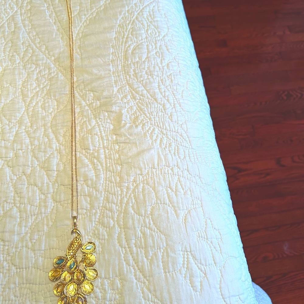 Gold necklace with aqua and holographic stones.